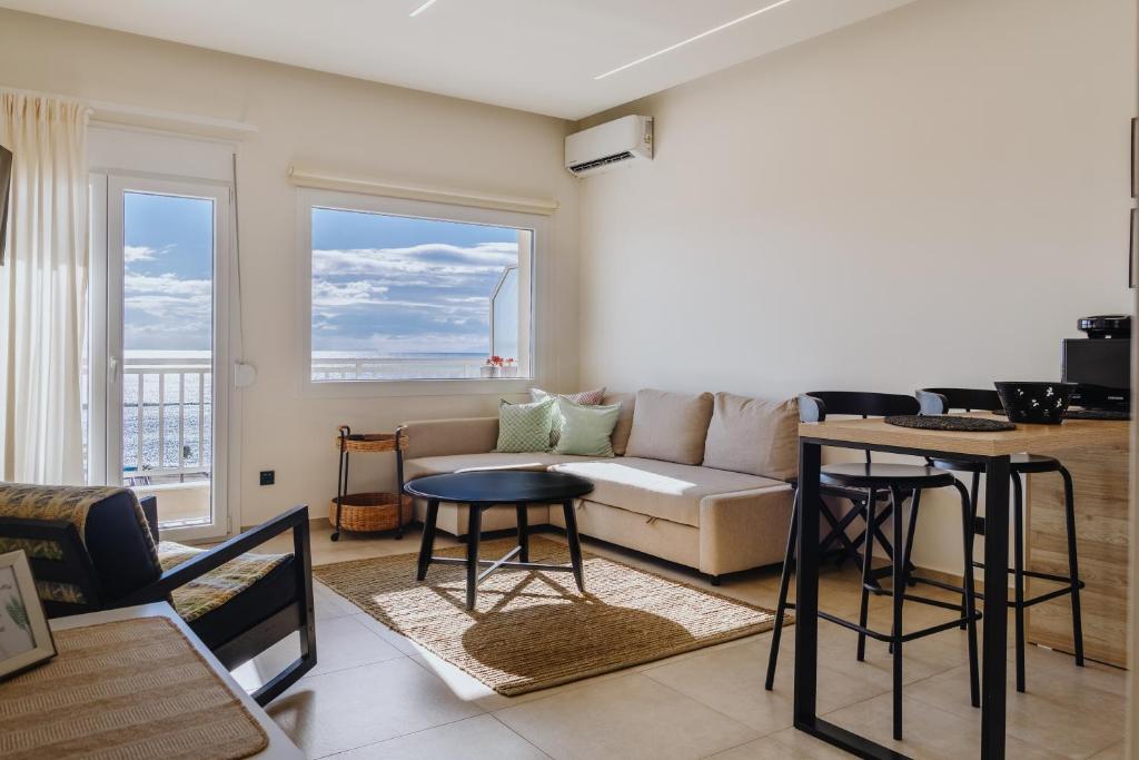 a living room with a couch and a table at Lighthouse apartments in Alexandroupoli