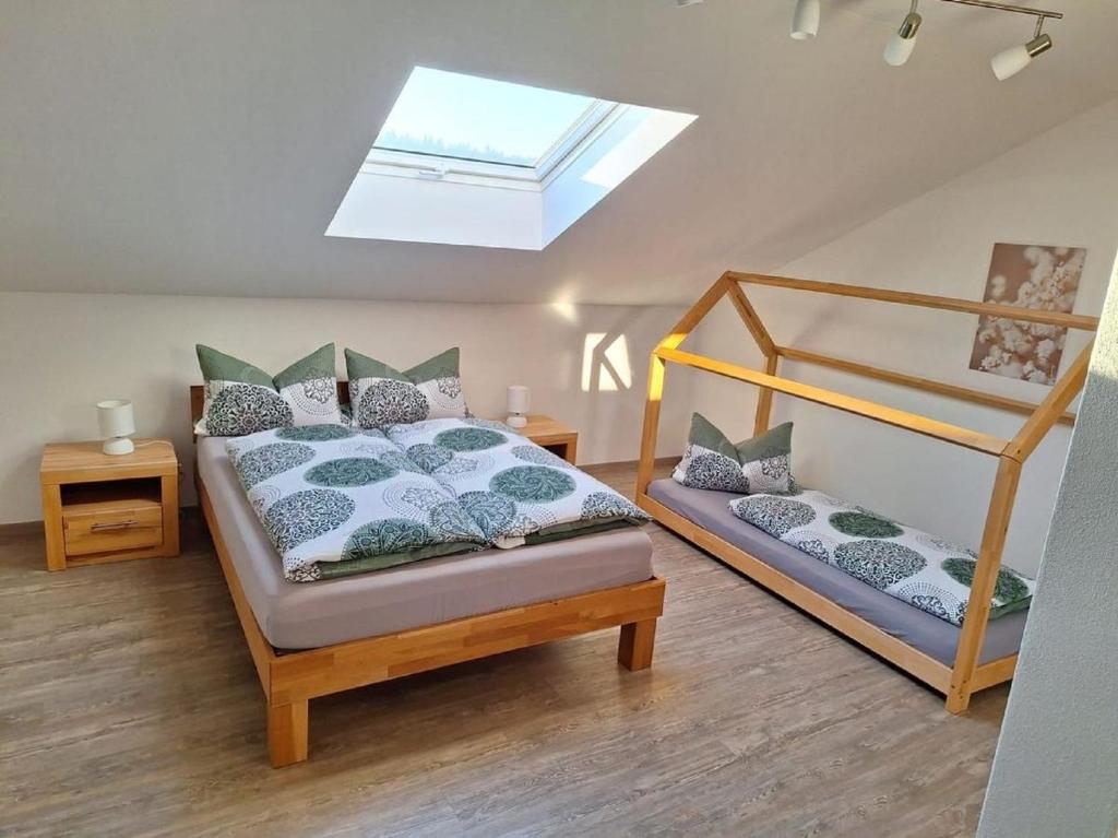 a bedroom with two bunk beds and a skylight at Ferienwohnung Koller in Lam