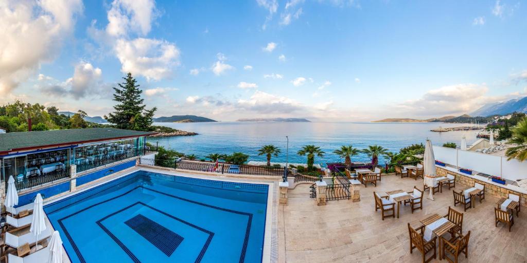 a resort with a pool and a view of the water at Aqua Princess Hotel in Kaş