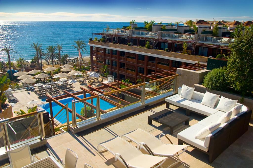 Blick auf ein Resort mit Pool und Meer in der Unterkunft Gran Hotel Guadalpín Banus in Marbella