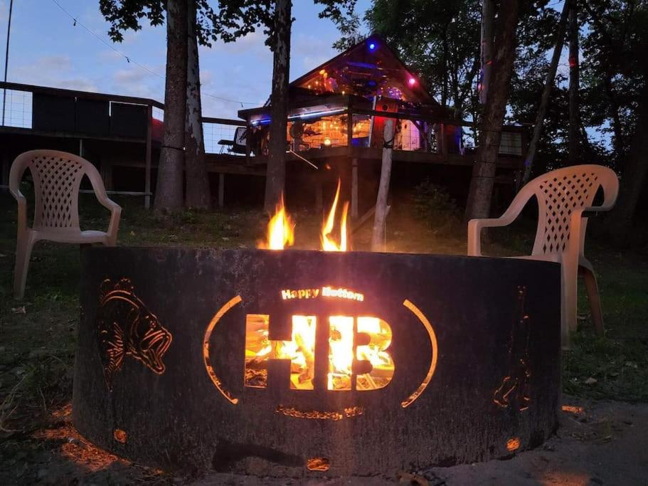 a fire pit with a sign that says fire at Happy Bottom Riverfront Cabin, Petersburg,WV in Rig