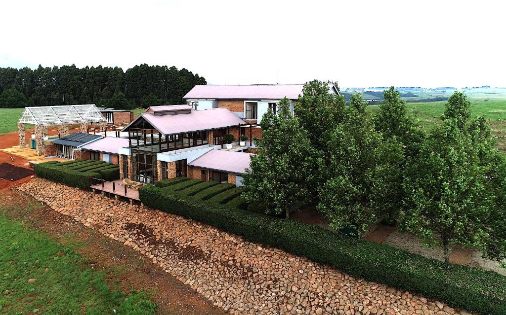 an aerial view of a house with a train at Vetho Farmhouse Dullstroom in Dullstroom