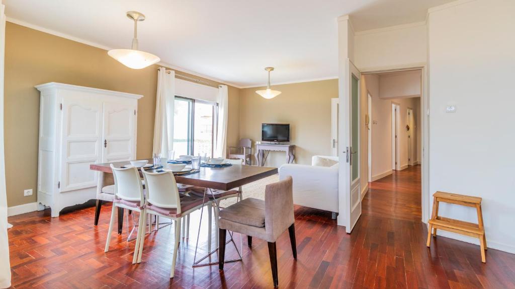 a dining room with a table and chairs at Fabulous Boavista Apartment by Unique Hosts in Porto