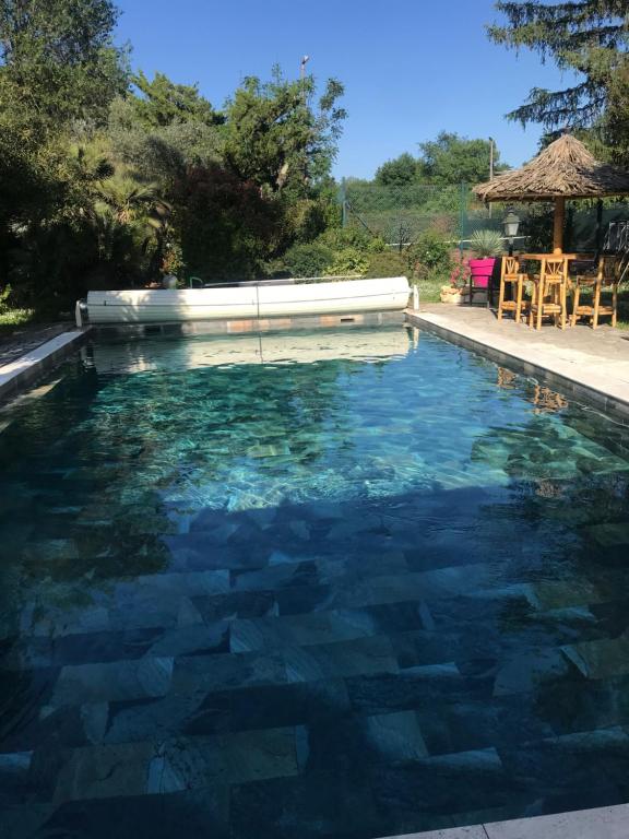 a swimming pool with clear blue water at Gîte du Gecko in Saint-Christol-lès-Alès