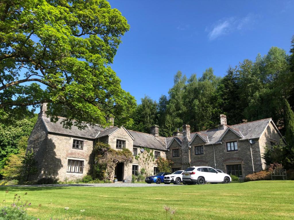 a large house with two cars parked in front of it at The Skreen in Builth Wells