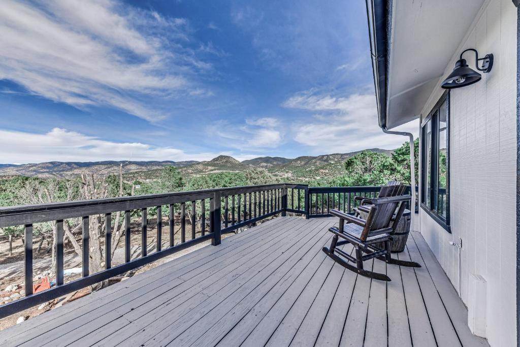 a deck with two chairs and a view of the mountains at High Rolls Cabin with Decks 11 Mi to Ski Cloudcroft in Cloudcroft