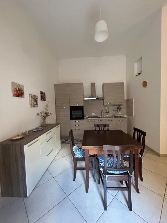 cocina con mesa de madera y sillas en apartment in the center of Castellammare del Golfo en Castellammare del Golfo