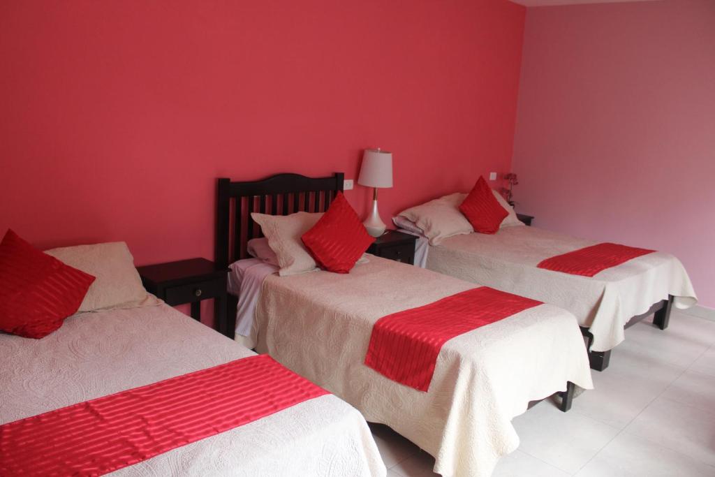Postel nebo postele na pokoji v ubytování Hotel Boutique La Orquidea