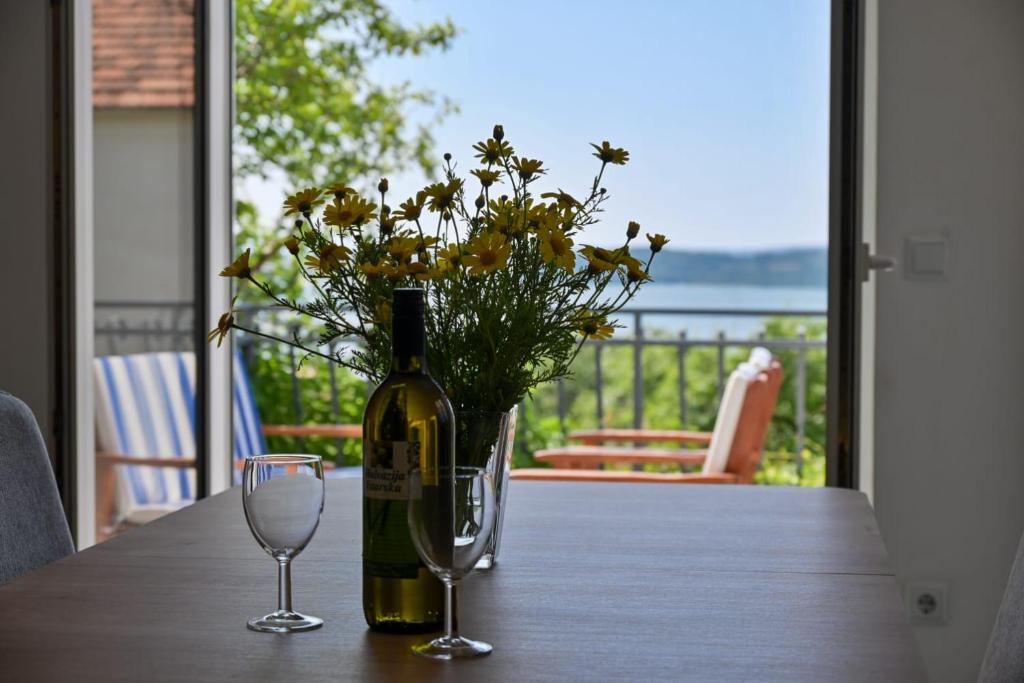 een fles wijn zittend op een tafel met een glas bij Rina Vacation home in Trogir