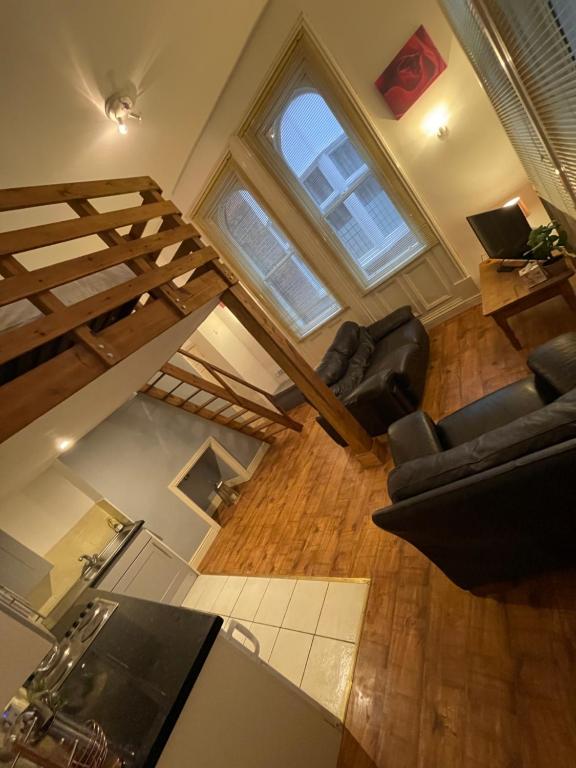 an overhead view of a living room with a spiral staircase at Mezz Apartment Four in Hull