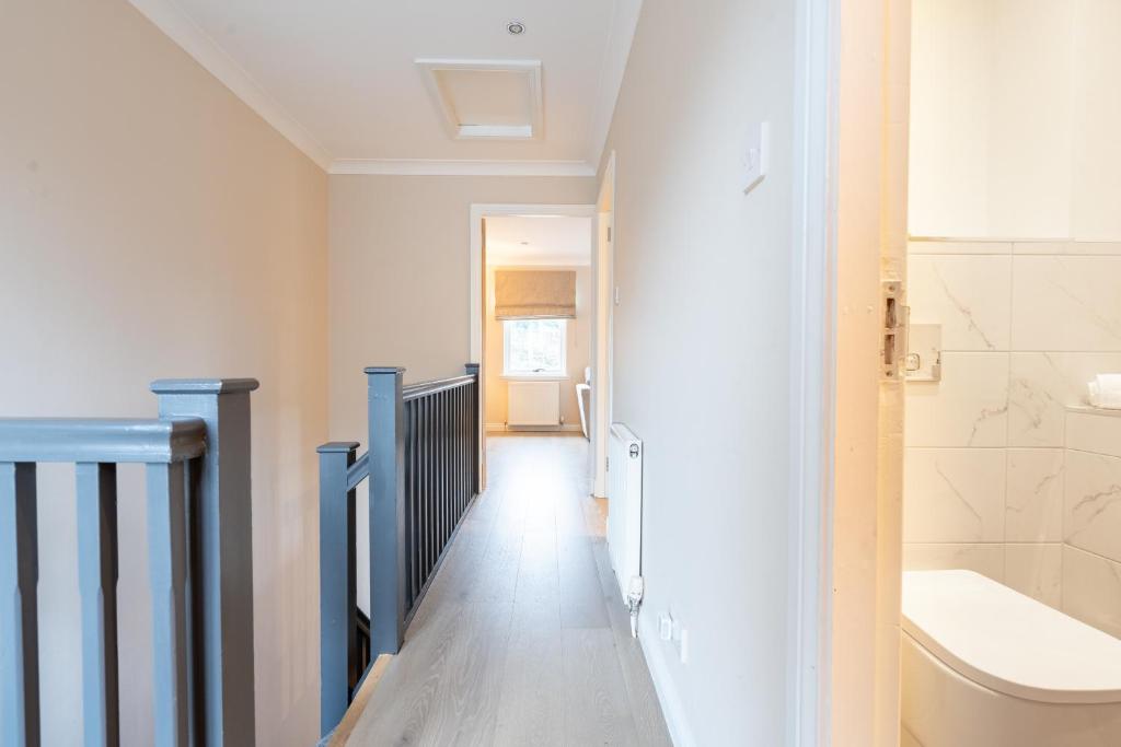 a hallway of a bathroom with a sink and a toilet at Steels cross House in Lanark