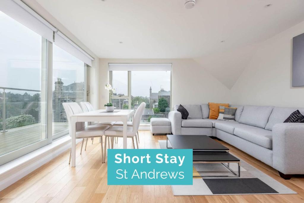 a living room with a couch and a table at Argyle Rigg - Central Elegant Townhouse - Balcony in St. Andrews