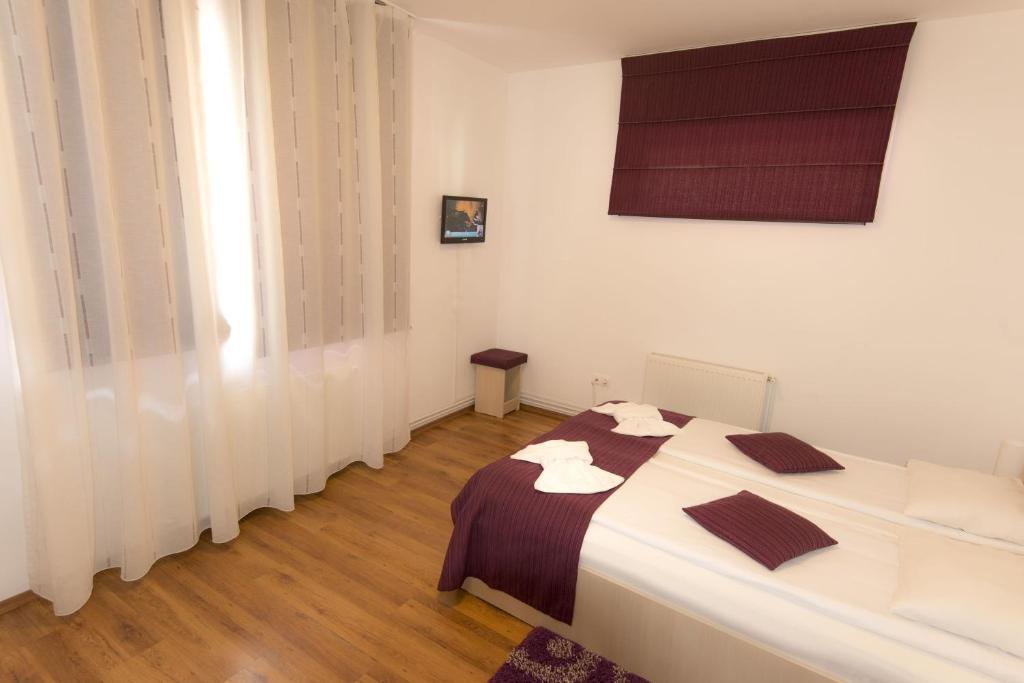 Postel nebo postele na pokoji v ubytování Vila Rigo Sovata