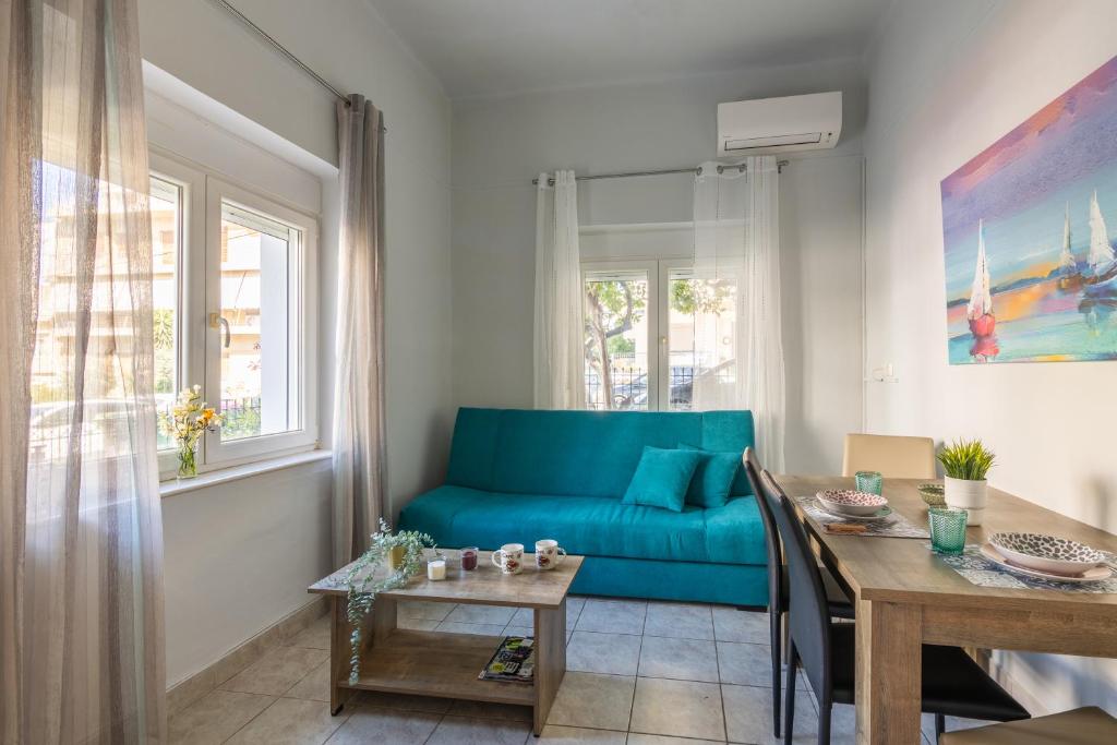 ein Wohnzimmer mit einem blauen Sofa und einem Tisch in der Unterkunft Lemon Tree House in Iraklio