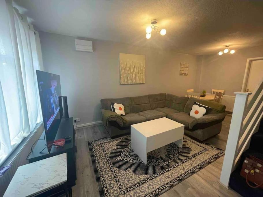 a living room with a couch and a table at Stylish 2 bedroom house Edgware, Barnet in Hendon