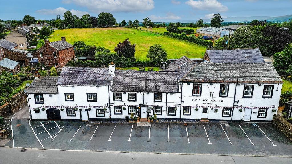 an overhead view of a white building with a parking lot at Black Swan in Penrith