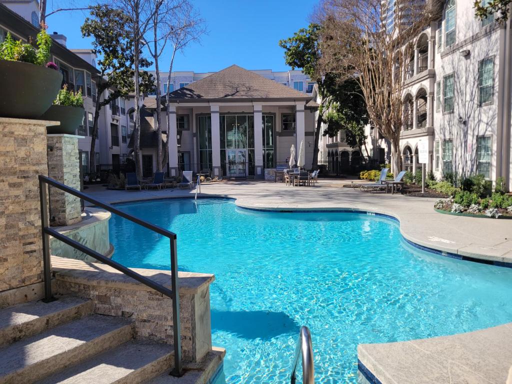 a swimming pool in front of a house at Best of Both Worlds in Houston