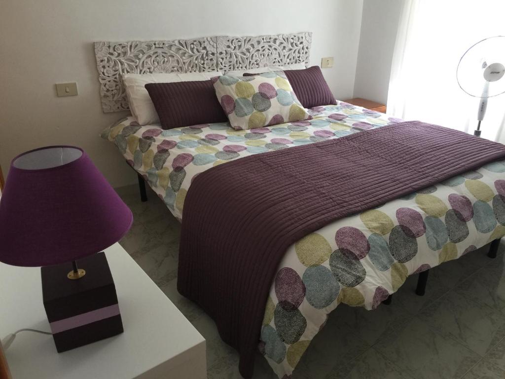 a bedroom with a bed and a purple lamp at Casarosaria Italie Molise Pietrabbondante in Pietrabbondante