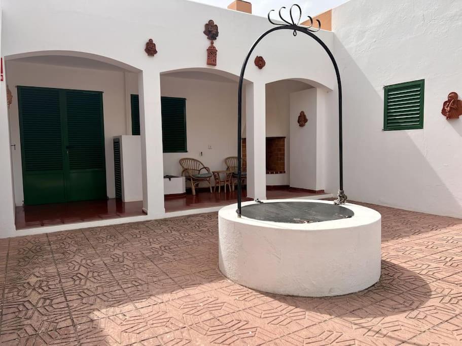 a room with a stone tub in the middle of a building at Villa Skiba Es Caló Formentera in Es Calo