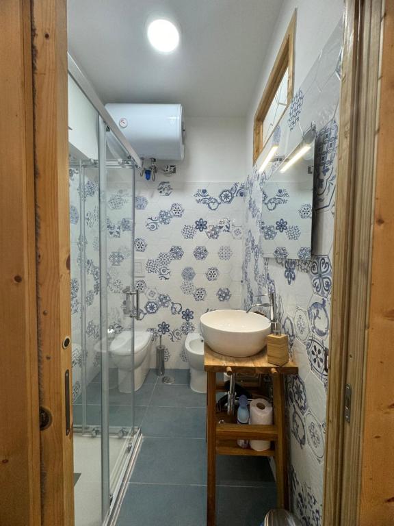 a bathroom with a sink and a shower and a toilet at Casa Gennarino in Naples