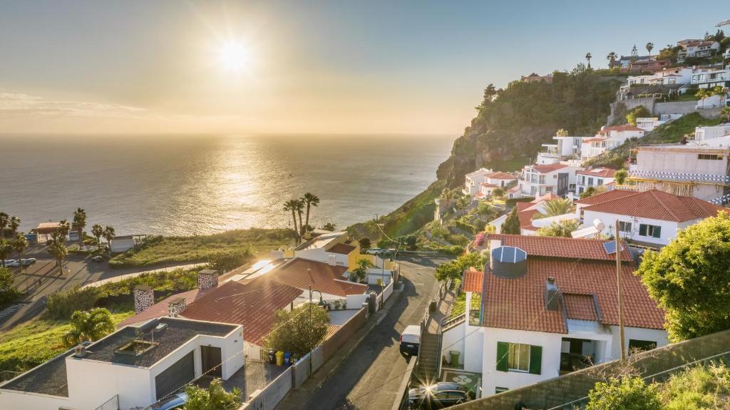 a view of a coastal town with the ocean at SUNSET VILLA in Caniço