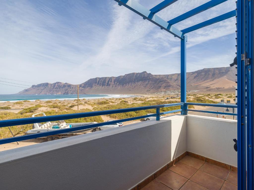 a balcony with a view of the ocean and mountains at Casa Joral, para surfear en Famara in Famara