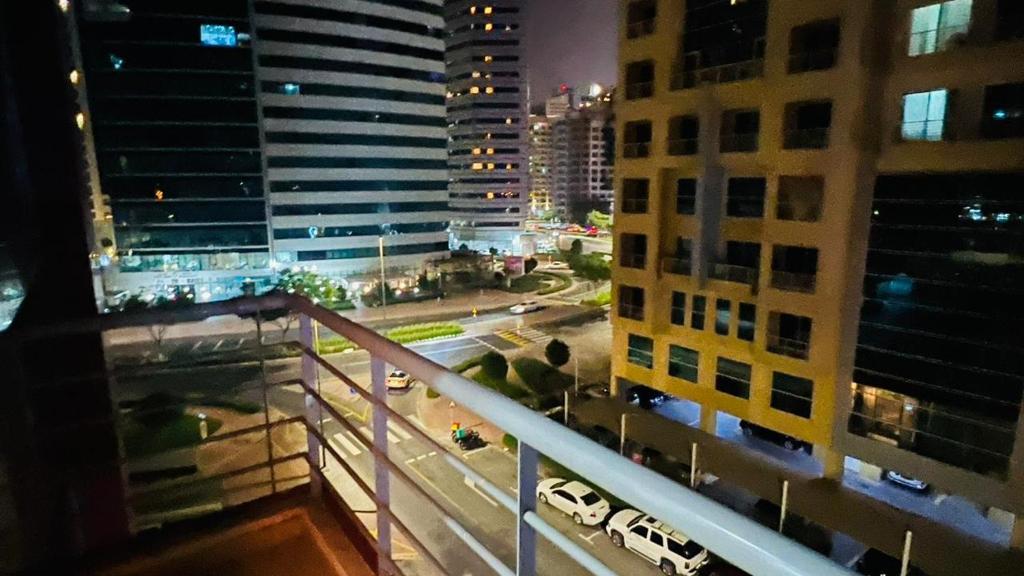 a view from a balcony of a city at night at Relaxing Closed Partition Room in Tecom Near Metro in Dubai
