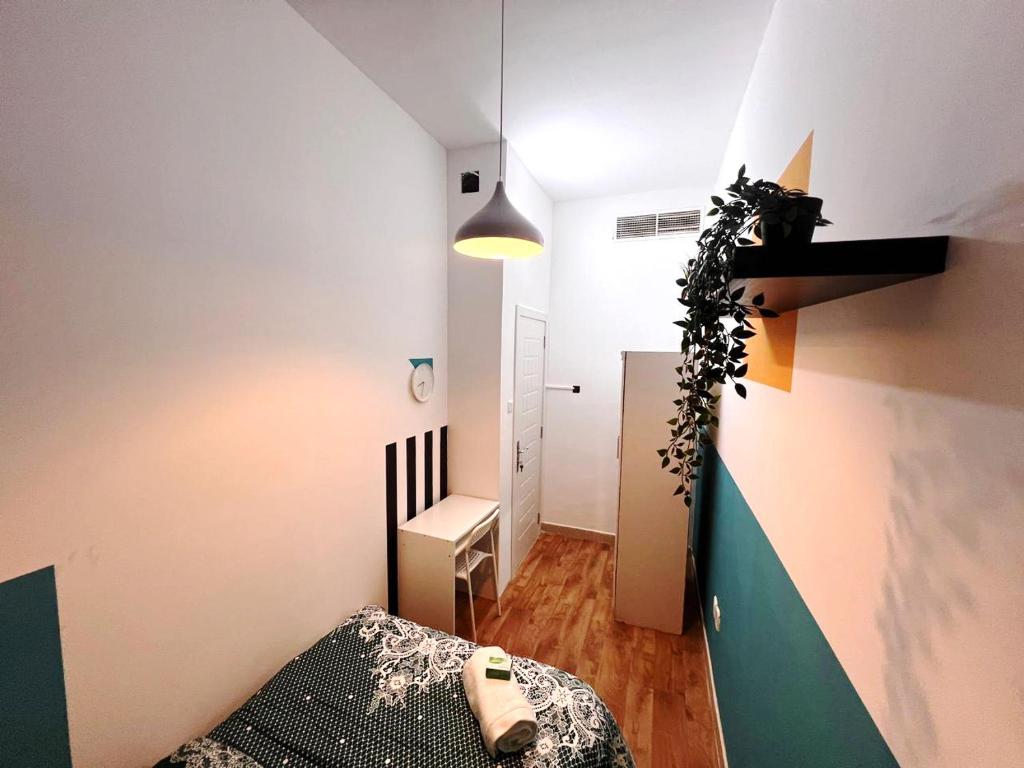 a small room with a bed and a hallway at Relaxing Closed Partition Room in Tecom Near Metro in Dubai