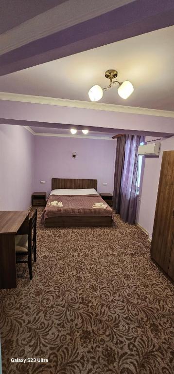 a large room with a bed and a table at Hotel international in Yerevan