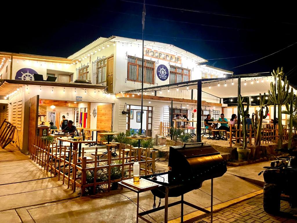 a restaurant with tables in front of a building at Capitan Brau's in Los Órganos