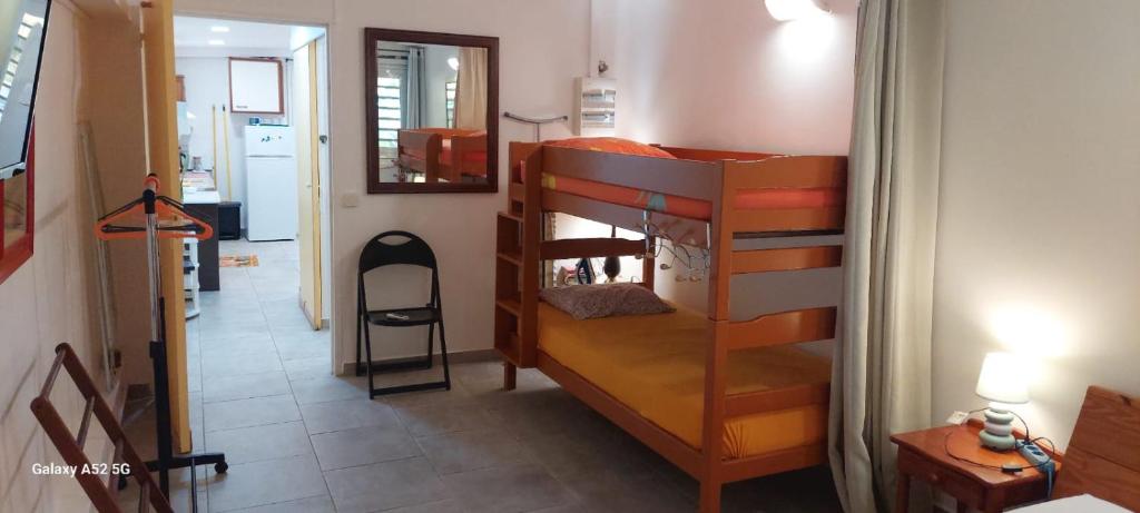 a room with two bunk beds and a hallway at Fetay Jaune in Baie-Mahault