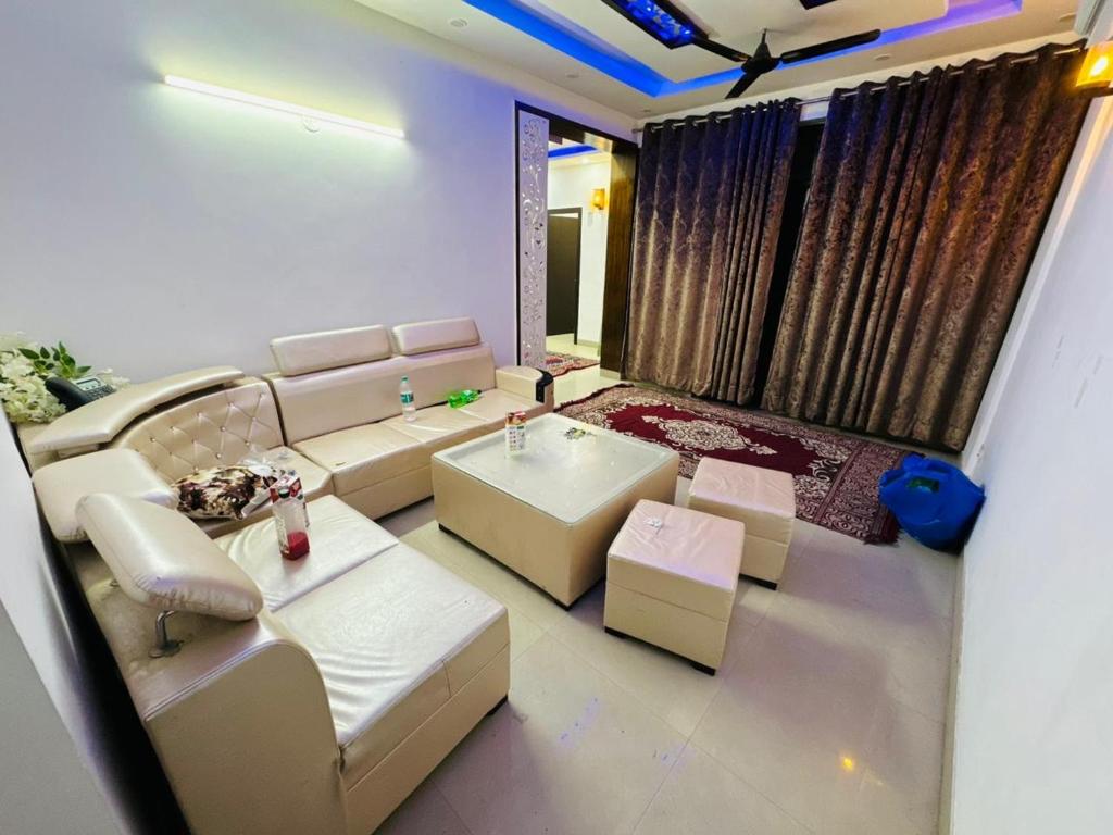 a living room with a couch and a table at exclusive apartment for bash in Faridabad