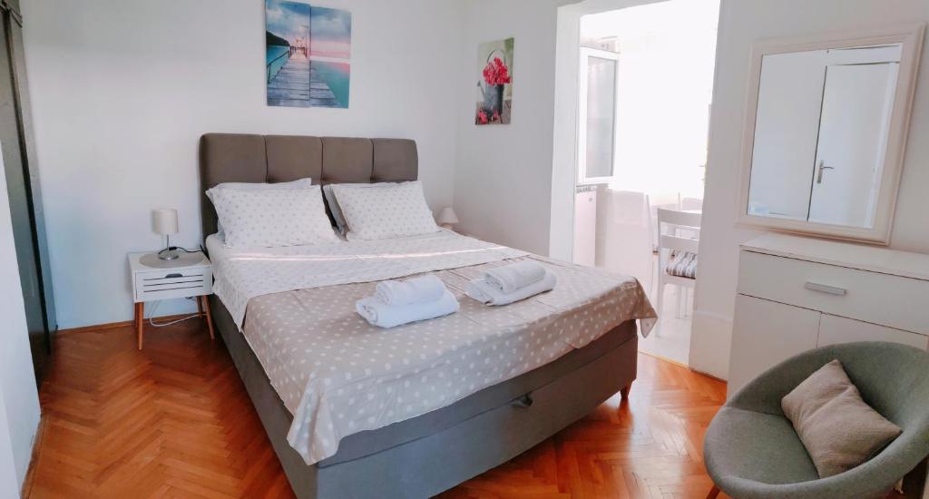 a bedroom with a bed with two towels on it at Studio Bobo in Rovinj