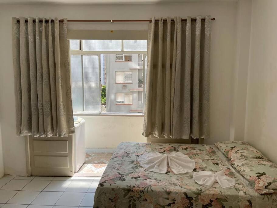 a bedroom with a bed and a window at Bela vista Rio in Porto Alegre
