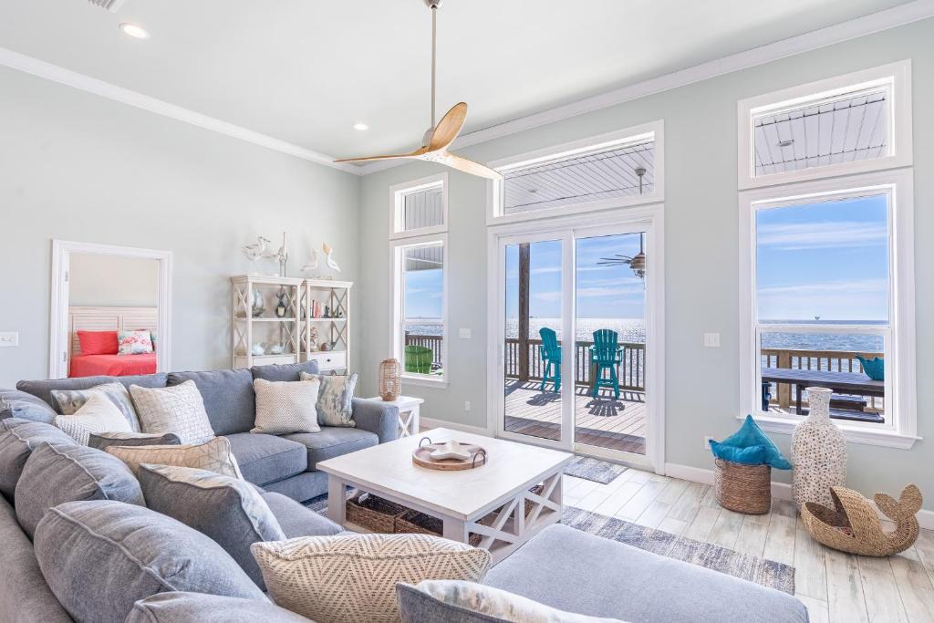 a living room with a couch and a table at Waves of Grace in Dauphin Island