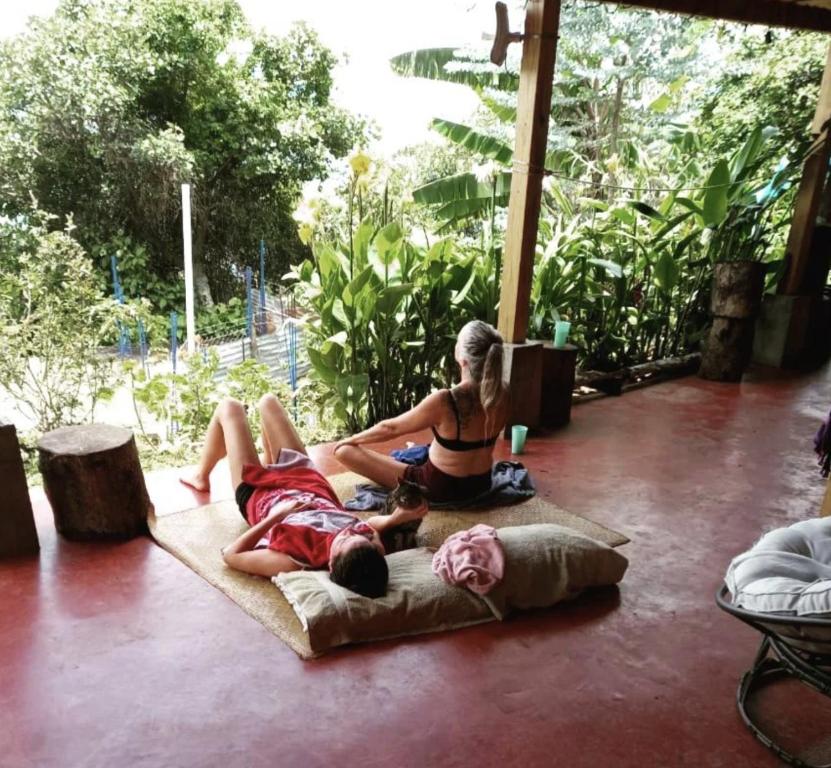 a woman and a child sitting on the floor at ELENA'S HOME STAY in Sololá