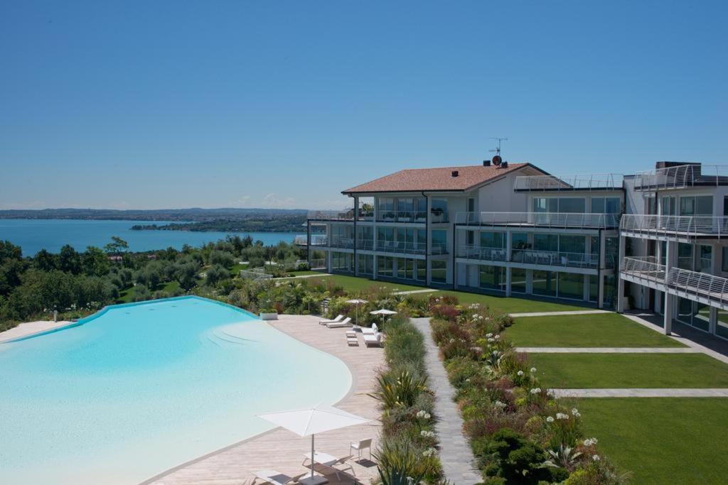 an aerial view of a resort with a large swimming pool at Garda Lake Luxury Life in Padenghe sul Garda
