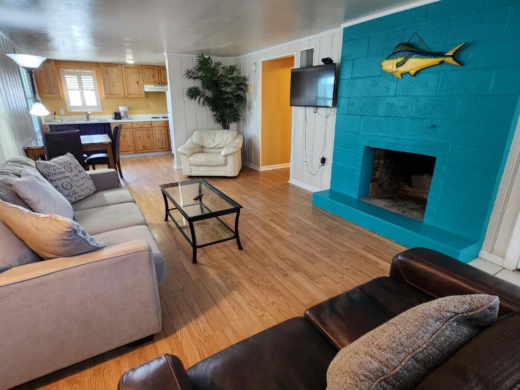 a living room with a blue wall with a fish on it at Eden Roc Apartments in Ocean City