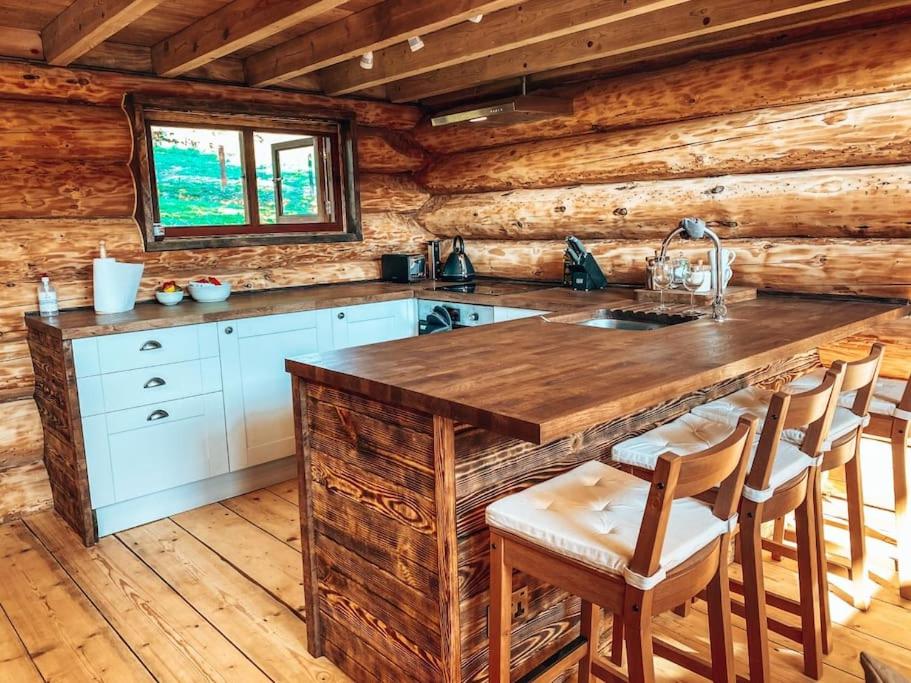 a kitchen with a large wooden counter in a cabin at Log Cabin/Hot Tub on Private Lake Jurassic Coast in Bridport