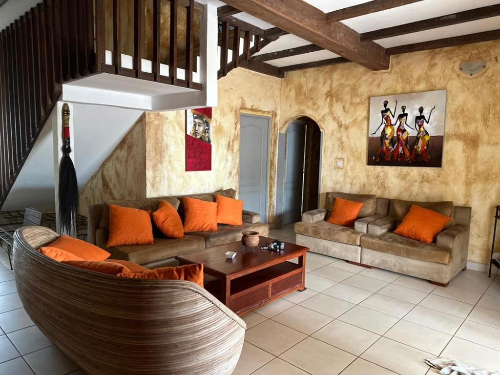 a living room with a couch and a table at La Villa Lou, Musée Des Arts Grand Batangua in Kribi