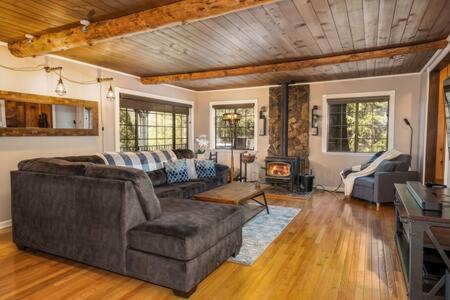 a living room with a couch and a fireplace at Cedar Ridge Hot Tub BBQ Sleeps 8 in Oakhurst