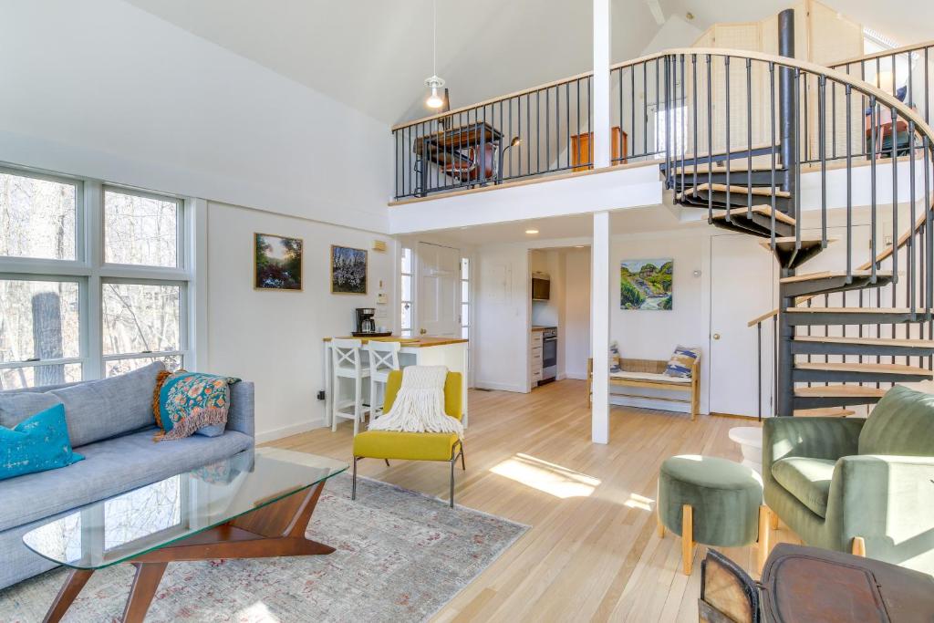 ein Wohnzimmer mit einem Sofa und einer Treppe in der Unterkunft Dreamy Hudson Valley Cottage with State Park Views in Garrison