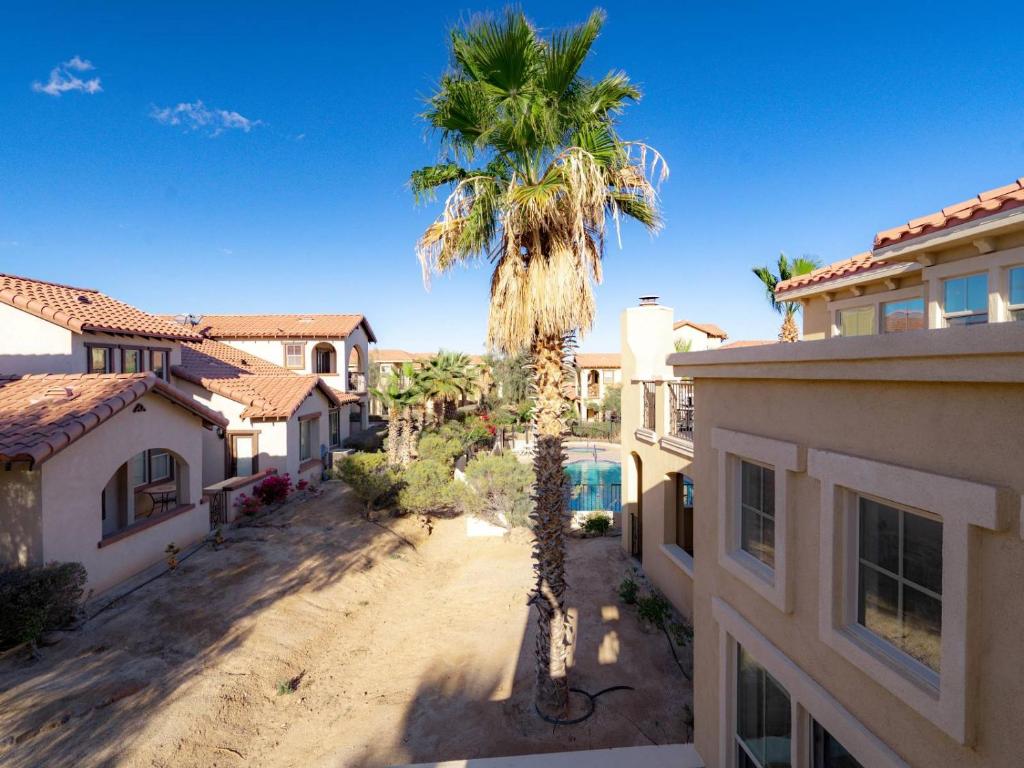 a palm tree in the middle of a house at POOL SIDE, with free WiFi and GOLF PASS in La Ponderosa