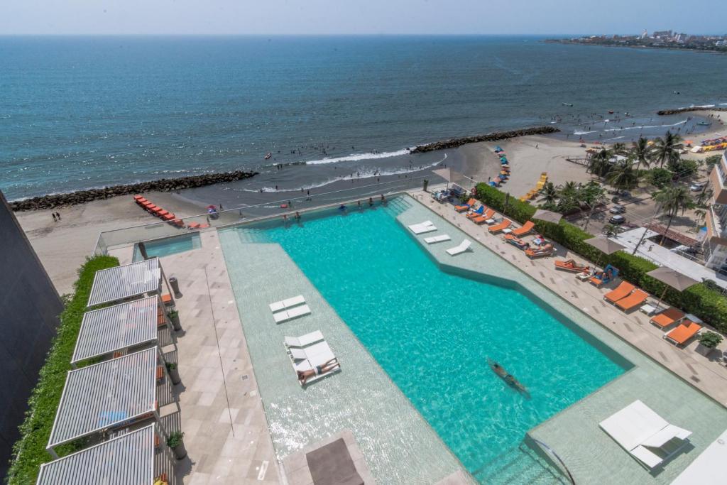 an overhead view of a swimming pool next to a beach at 41st Fl Beach Condo in Bocagrande in Cartagena de Indias