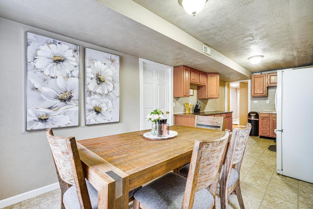 a kitchen with a table with chairs and a refrigerator at Pet-Friendly Utah Apartment 2 Mi to Amphitheatre in West Valley City