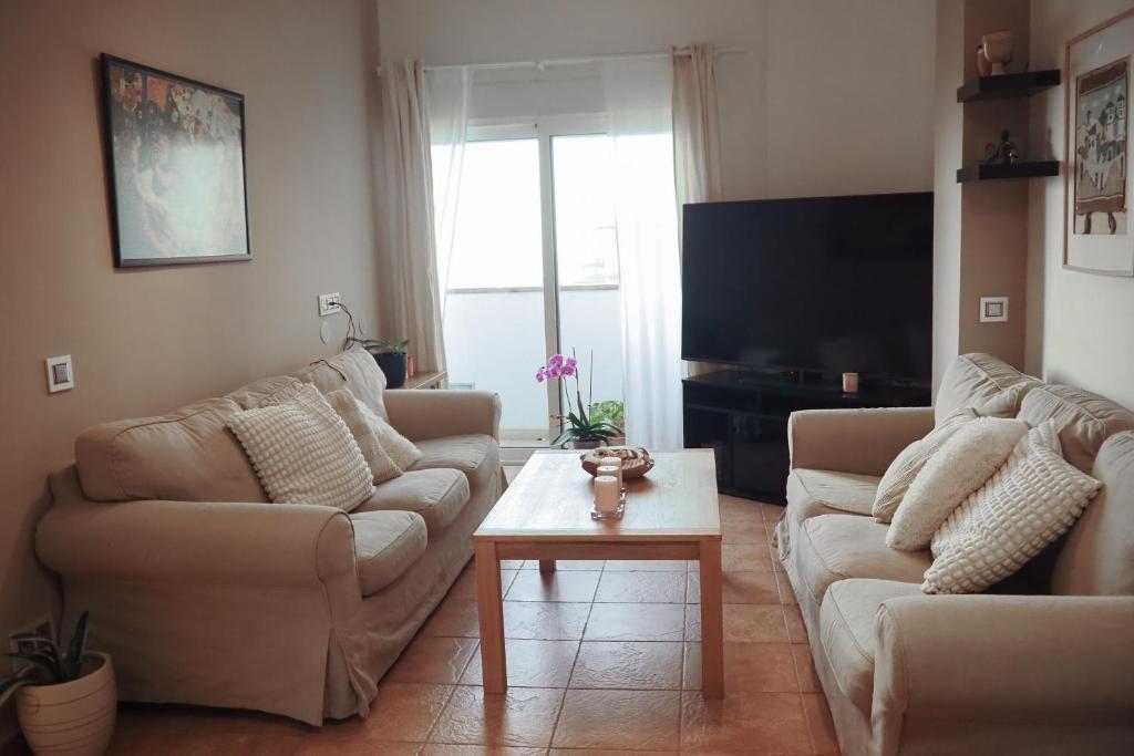 a living room with two couches and a coffee table at Breathtaking Sunsets Flat in Las Palmas de Gran Canaria