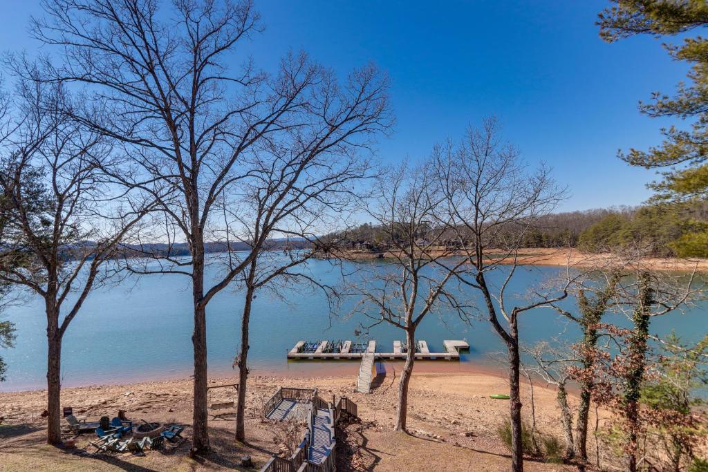 a dock on the shore of a lake with trees at Lakefront Townhome with Dock 6 Mi to Blue Ridge! in Morganton