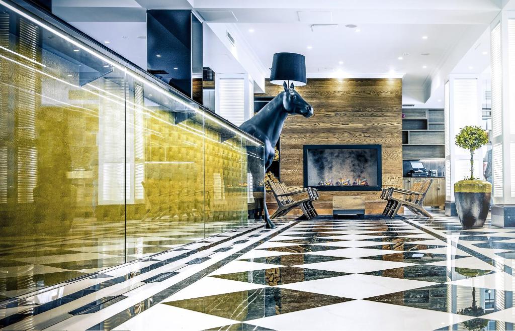 a lobby with a statue of a horse on the wall at Hotel Lilla Roberts in Helsinki