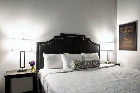 a bedroom with a large white bed with two lamps at TWO Bold 2BR 2BA Apartments by CozySuites in Indianapolis