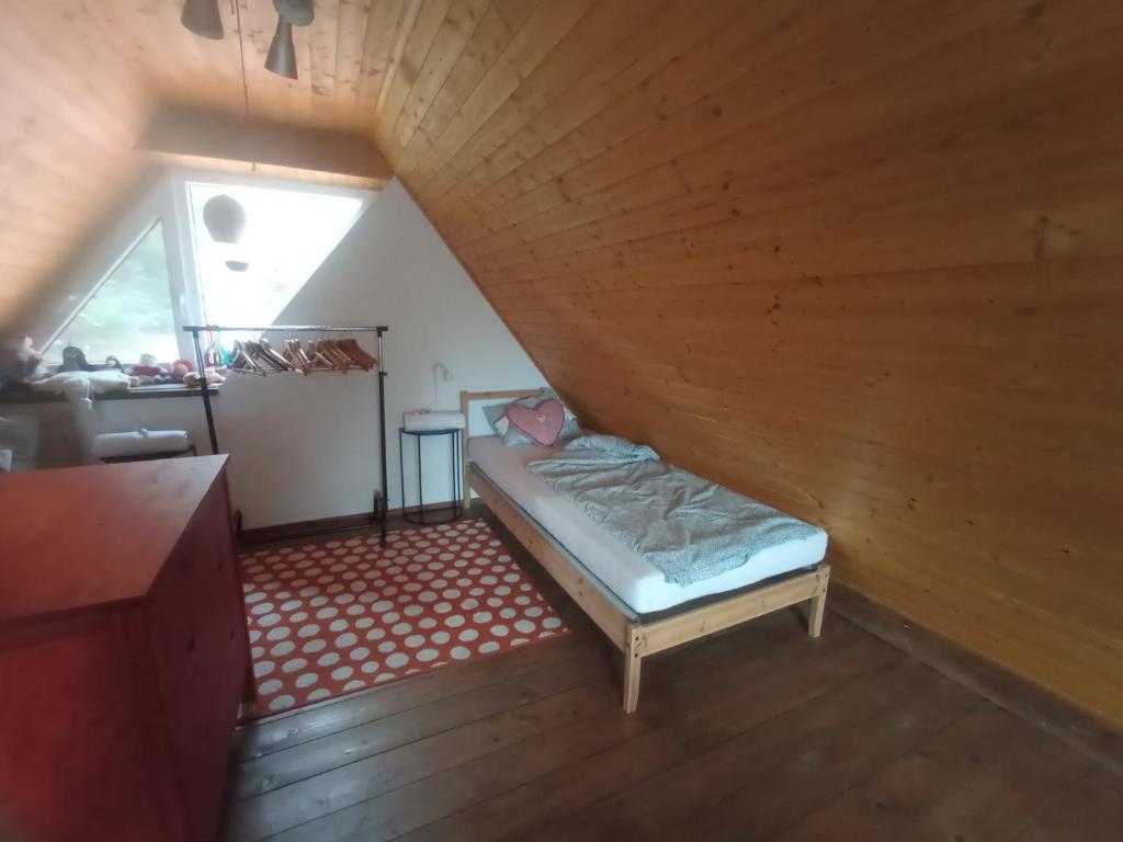 a room with a bed in a attic at Pele vendégház in Velem